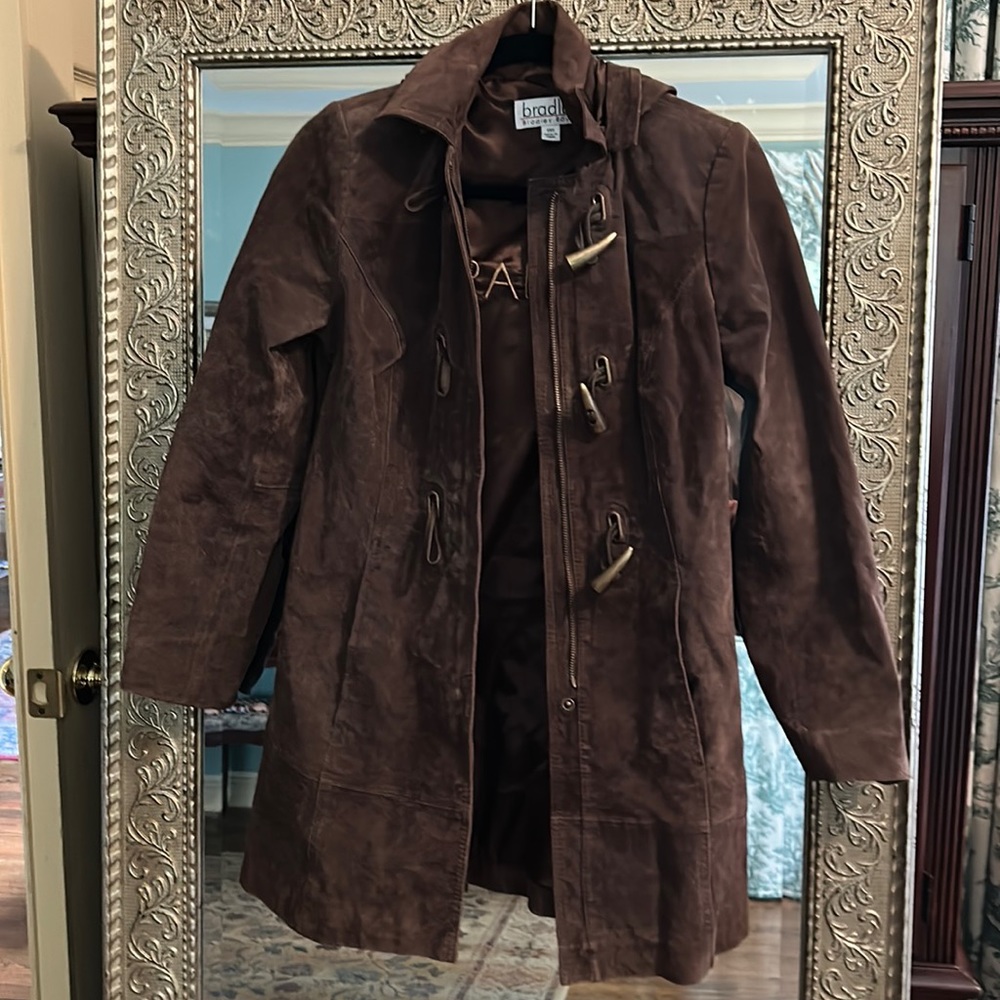 Brown leather trench with hood and gold accents.